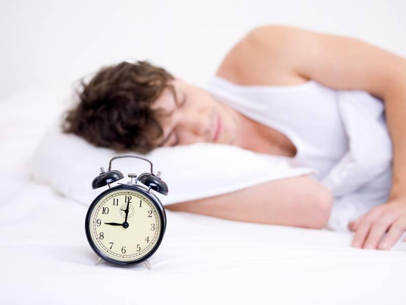 man-sleeping-with-alarm-clock.jpg